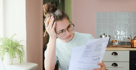 home-buyers-Knowing-the-Costs2 A lady, looking confused while holding paper documents
