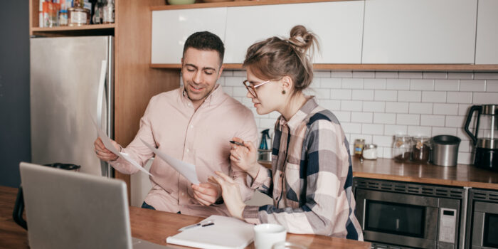 Ready for your first big investment Couple sitting in front of a laptop making financial decisions