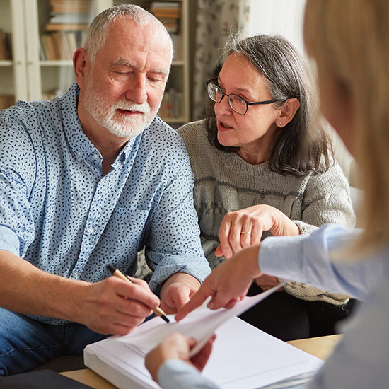 Seniors sign a contract or power of attorney at home after a consultation