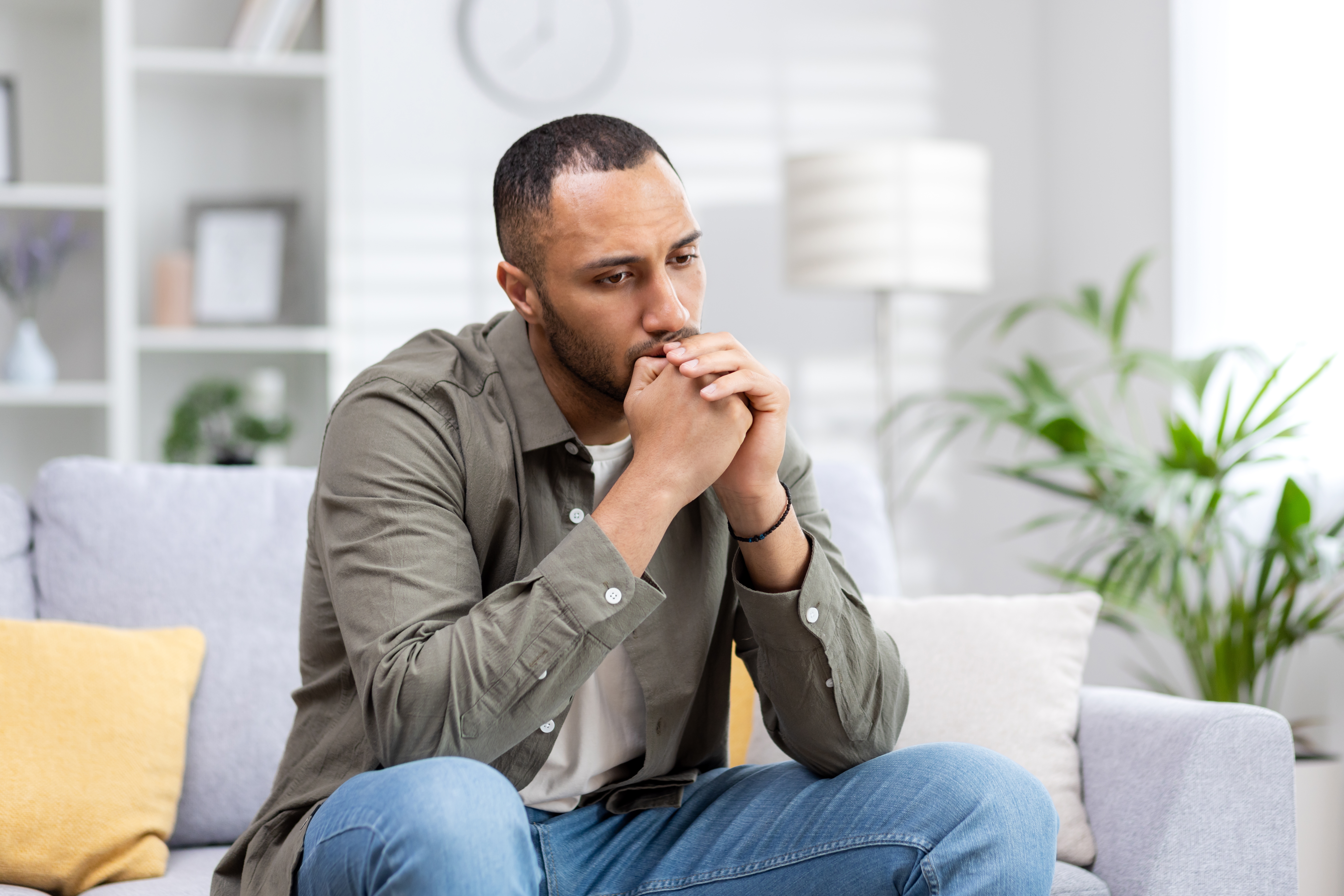 Depression,In,A,Young,Latin,American,Man,Sitting,Thoughtfully,And Depression,In,A,Young,Latin,American,Man,Sitting,Thoughtfully,And