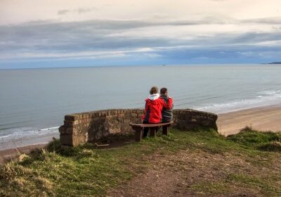 Stock_People looking out to sea_400x298.png Two people sitting on a bench looking out to sea